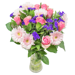 Arranged with a Hampton florist's love for subtle artistry, this bouquet brings together the delicate harmony of blush-toned gerberas and romantic pink roses, each bloom hand-selected for softness and form. The composition evokes a painterly scene-petals blending seamlessly from pale blush to vibrant medium pink, while the striking addition of deep purple statice offers playful punctuation and a hint of woodland fragrance. Crisp green leaves, fresh as if gathered near the waterways of Hampton Court, provide a lush foundation for the pastel blooms rising above. The bouquet, cradled in a sleek glass vase, glows beneath soft daylight, its colours luminous like the first light spilling over Marlow Crescent. Designed for moments of heartfelt celebration-whether a cheerful get-well wish, a thoughtful birthday surprise, or a gesture of lasting affection-each detail speaks of the careful craftsmanship and local sensibility that define flower delivery in Hampton. The overall effect is uplifting, elegant, and joyfully bespoke, inviting you to experience the serene charm of a hand-tied bouquet crafted with intent and genuine delight.